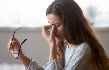 Close up exhausted woman massaging eyelids, taking off glasses, tired freelancer or student suffering from eyestrain or dry eye syndrome, feeling dizziness or headache after long hours work